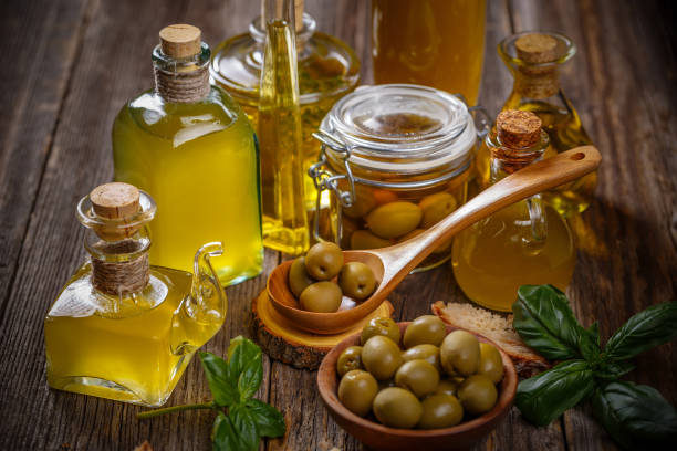 istock Olive oil glass bottles with olive berries 1045844620