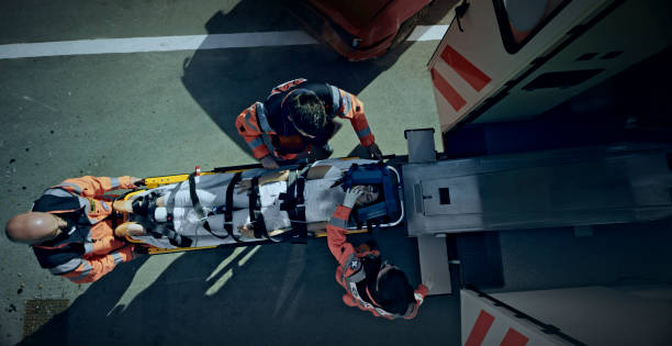 istock Injured woman being given an oxygen mask while being loaded into ambulance 1045845356