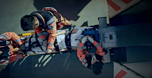 istock Injured woman being given an oxygen mask while being loaded into ambulance 1045845378