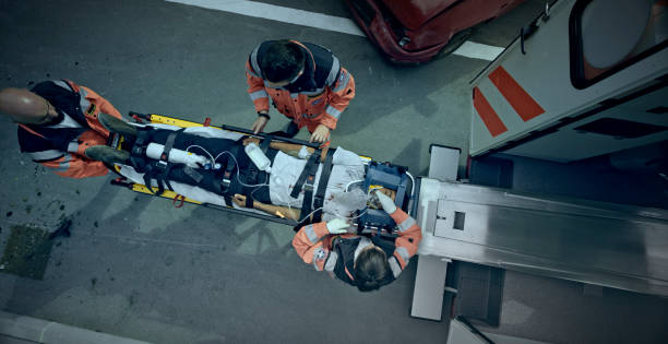 istock Injured man being given an oxygen mask while being loaded into ambulance 1045845380