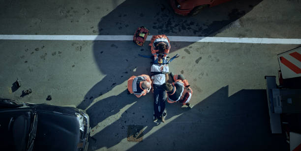 paramedic team immobilizing male injured in car crash - stretcher imagens e fotografias de stock