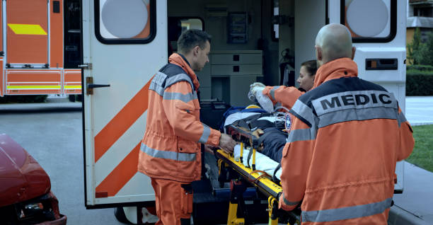 istock Paramedics loading injured person into ambulance 1045845432
