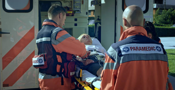 istock Paramedics loading female car accident victim on stretcher into ambulance 1045845468
