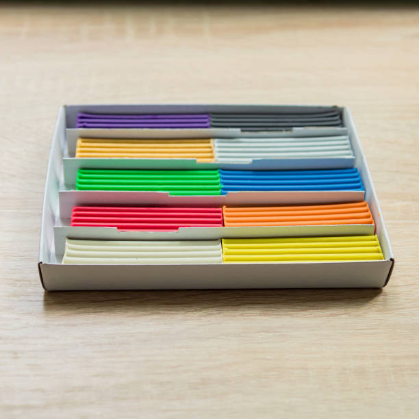 istock Set of multicolored plasticine bars for modeling on wooden table. Top view, eduction and creativity concept 1045850056