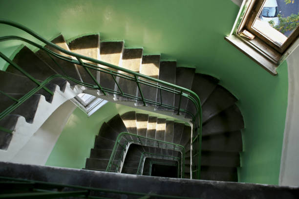 istock Downward spiral vintage staircase in old building. 1045857054