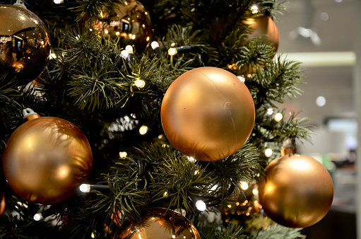 Close-up image with Gold Christmas Balls on tree, indoor