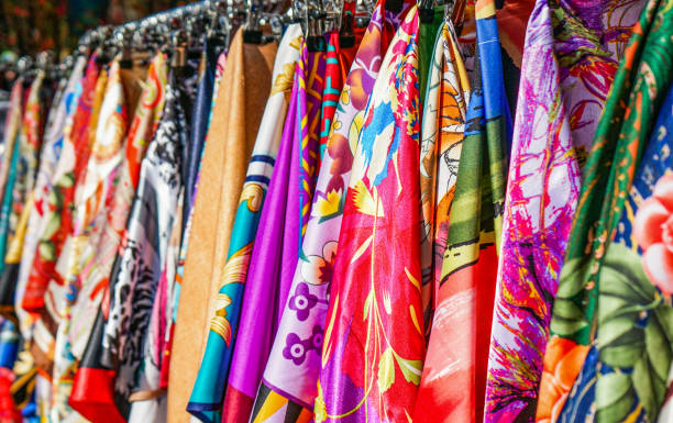 istock Many bright silk neckerchiefs on the store rack. 1045859972
