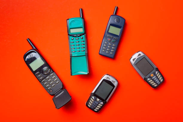 istock Old vintage mobile cell phones on red orange background 1045860152