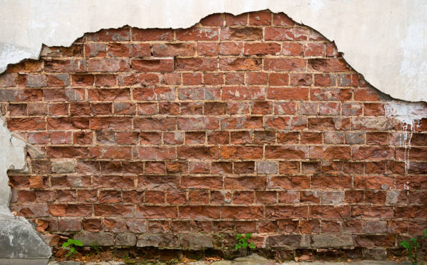 istock Ruined wall of old brick house 1045866388