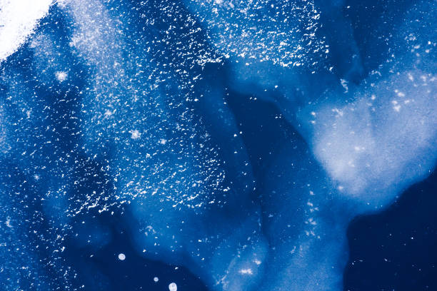istock Frozen blue water surface and wave covered with ice, snow abstract winter background wallpaper 1045870002