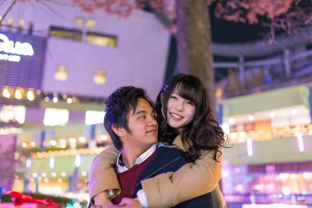 istock Happy young couple having fun together in Chrismas lights 1045873094