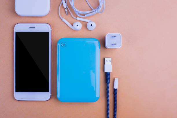 istock Smart phones and charging. On the table Orange background 1045873262