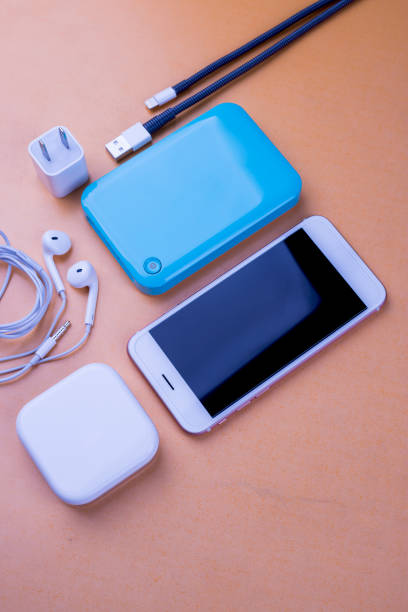 istock Smart phones and charging. On the table Orange background 1045873398