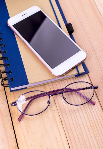 istock Tablet and notebook placed on a wooden background. 1045873542