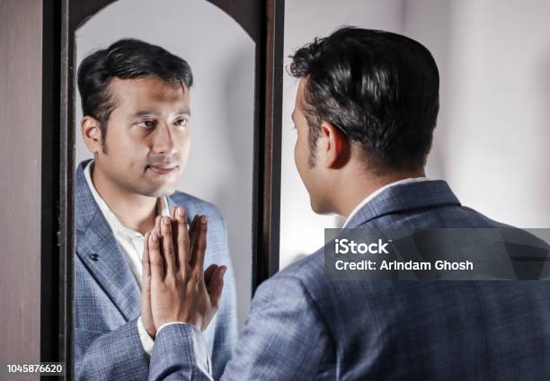 Asian Man In Suit Looking After His Appearance In Front Of A Mirror Beauty Styling Lifestyle Stock Photo - Download Image Now