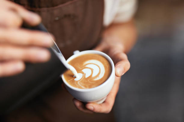 istock Coffee Art In Cup. Closeup Of Hands Making Latte Art 1045880970