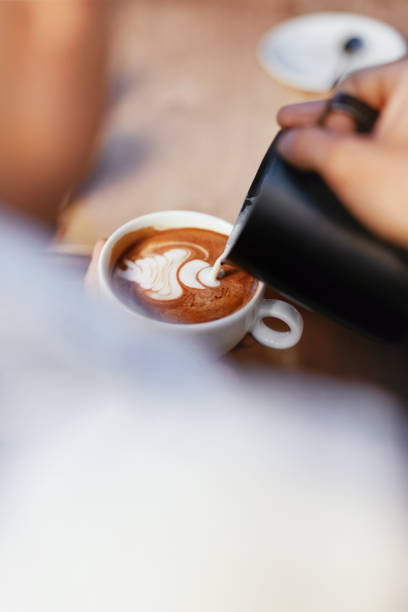 istock Coffee Art In Cup. Closeup Of Hands Making Latte Art 1045883204