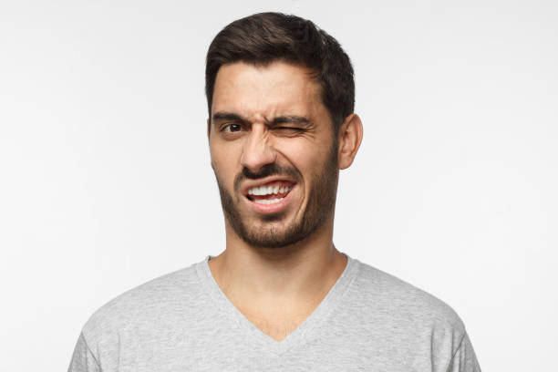 istock Ugh, disgusting! Shocked young man looking at something unpleasant and bad, isolated on gray background. Negative emotion concept 1045886766