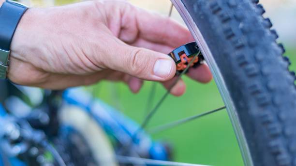 istock Technician centering bike wheel with dedicated spoke wrench 1045887670