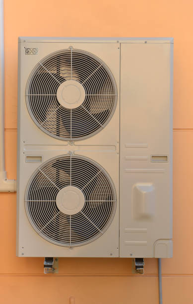 istock Close up Air compressor machine part of air conditioner system on house wall background. 1045887766