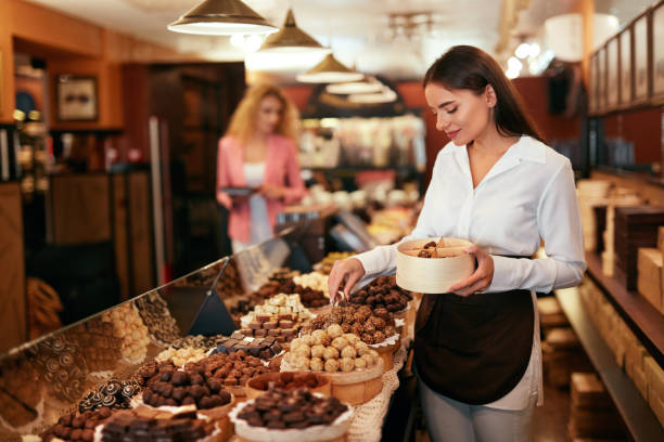 istock Chocolate Store. Woman Working In Chocolate Shop 1045891150