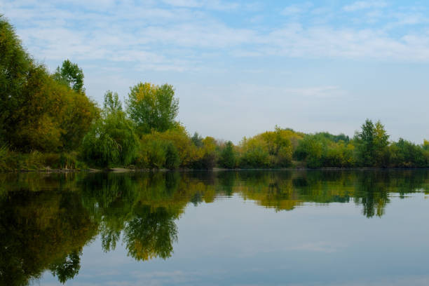 istock Autumn forest reflected in water. Colorful autumn landscape. 1045891540
