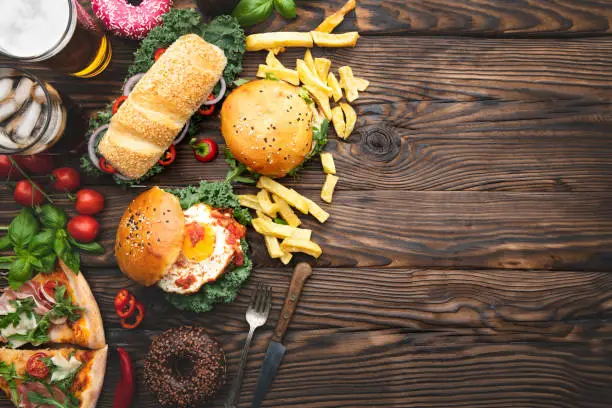 Photo of Close up of fast food snacks and drink on table