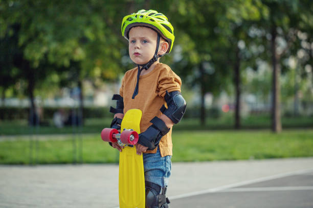 istock A little boy enjoys a yellow cruiser penny plastboard 1045891824