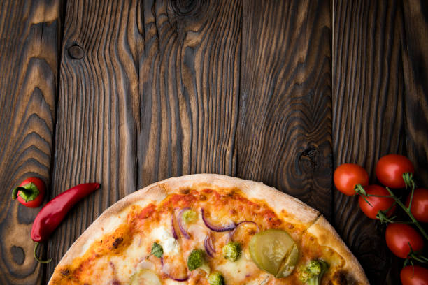 istock Hot italian pizza on wooden table 1045894278