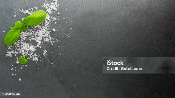 Basil With Alt On Slate Stock Photo - Download Image Now - Salt - Seasoning, Black Color, Slate - Rock