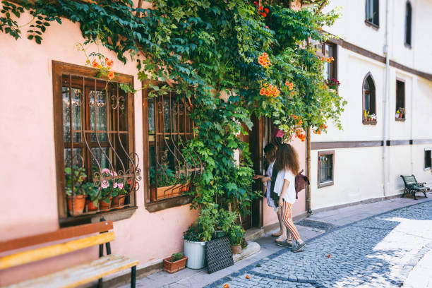 istock Woman opening a front door with a key 1045894586