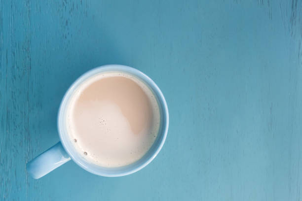 istock Milk coffee in a blue cup on pastel blue wooden floor 1045909252