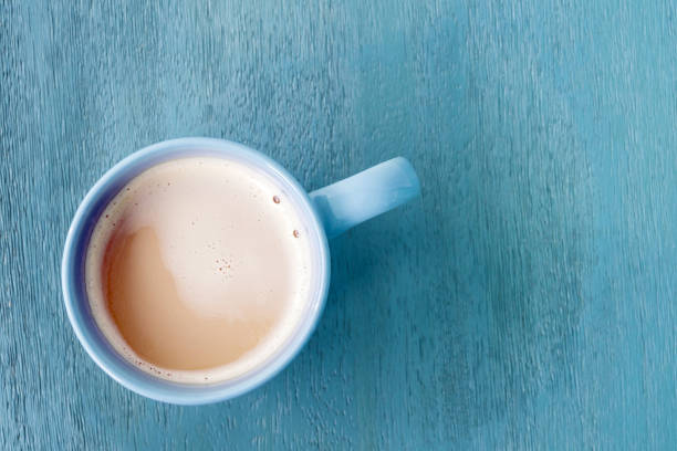 istock Milk coffee in a blue cup on pastel blue wooden floor 1045909256