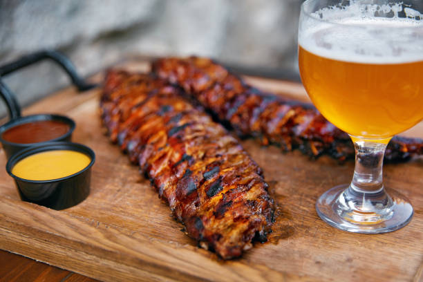 istock Barbecue Ribs And Beer On Table In Restaurant Closeup 1045909608