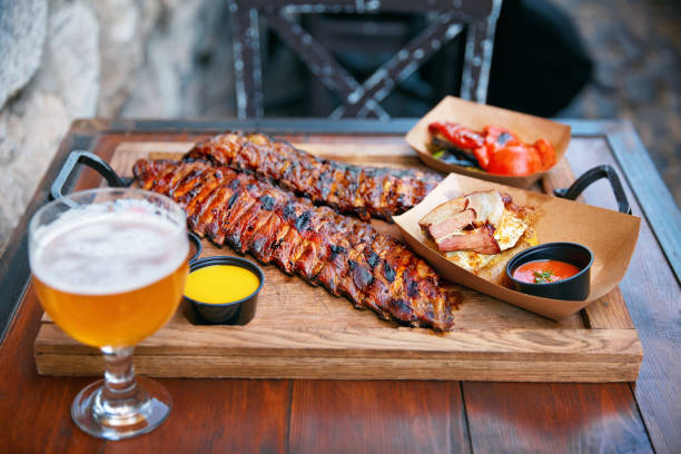 istock Barbecue Ribs And Beer On Table In Restaurant Closeup 1045909922