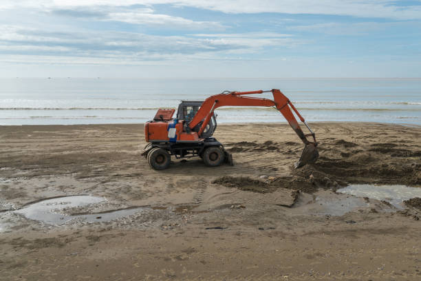 istock Excavator working on the beach to smooth the sand before summer season beginning 1045909940