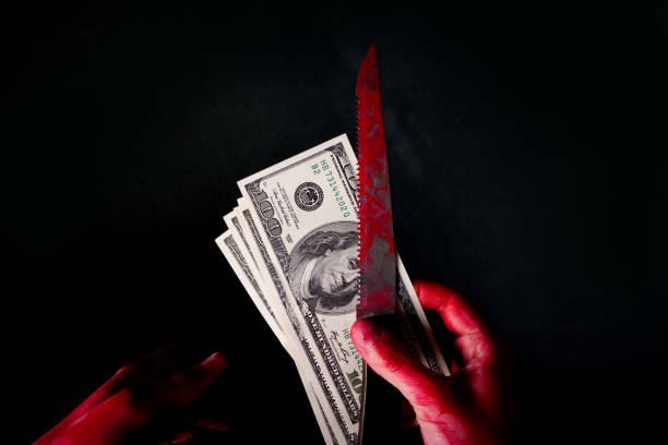 istock hungred dollar bills in blood on dark background 1045909980