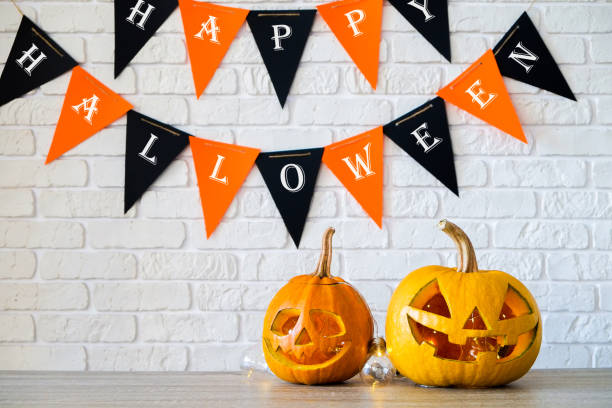 istock Halloween themed image with carved pumpkins in house party environment. 1045914082