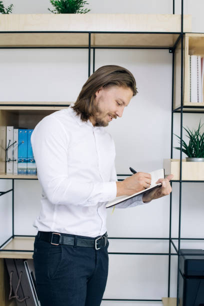 istock Young businessman taking notes on his agenda 1045917688