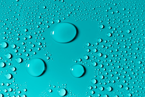 Macro image of water drops on blue surface