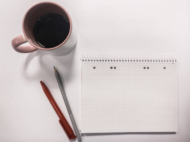 istock Coffee cup with writing pad and pencils 1045929326