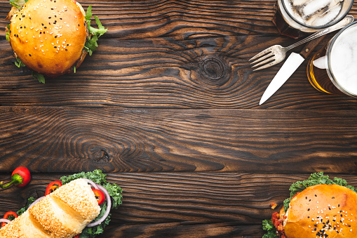 Fresh burgers and sandwich meal on wooden background. Top View
