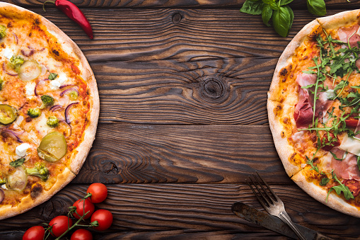 Hot italian pizza on wooden table with space on text