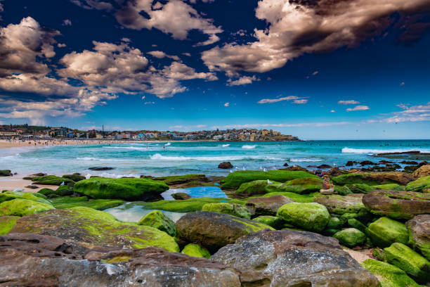 Sun Shower at Bondi Beach Clouds set in over Bondi Beach just before a Sun shower berk stock pictures, royalty-free photos & images