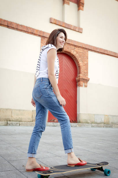 istock Teen teaches mom to skateboard 1045938582
