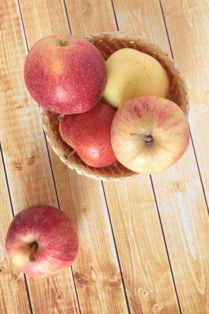 istock Apples on wooden background 1045938914