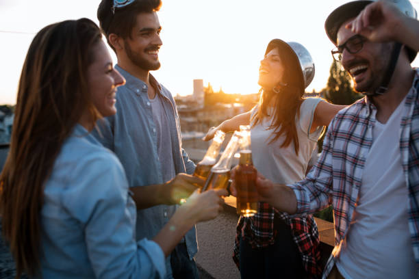 istock Group of happy friends having party on rooftop 1045942520