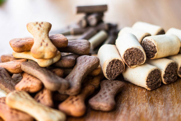 istock Dog tasty colored biscuits on wooden background, snacks for dogs 1045950324
