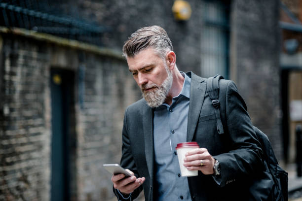 istock Businessman with coffee and smart phone 1045951110