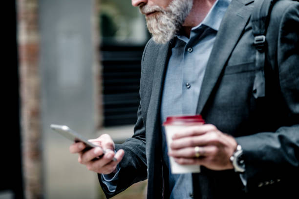 istock Businessman with coffee and smart phone 1045951118